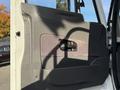 The image shows the interior door panel of a 2011 International 7500 featuring a handle and textured design