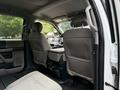 Interior view of a 2020 Ford F-550 showing the back seats and center console with gray fabric upholstery and seat belts