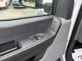 Interior view of a 2023 Ford F-450 Super Duty driver's side door with controls for windows and mirrors