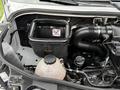 Under the hood of a 2019 Mercedes-Benz Sprinter with visible engine components including a black air filter box and a plastic coolant reservoir