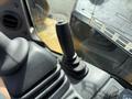 Close-up of the control joystick of a 2022 Caterpillar 306 excavator highlighting its ergonomic design and functional grip