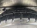 Close-up of a tread pattern on a tire of a 2021 Ford Transit-350 showcasing deep grooves and a rugged design for traction