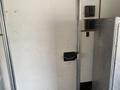 A white door on a 2008 Wells Industries Inc EW1422 with a metal handle and an electronic lock system visible on the side