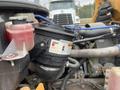A close-up view of the engine compartment of a 2007 Freightliner B2 showing various mechanical components including a filter and fluid reservoir