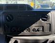 Dashboard of a 2019 Ford E-450 featuring a radio control panel with knobs and buttons for climate and audio settings
