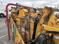 A yellow 2015 Vermeer Corporation BC1200XL wood chipper with visible rust and wear featuring controls and labeling on its side