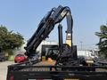 A 2009 Ford F-450 Super Duty truck with a hydraulic crane mounted on the back showcasing its heavy-duty construction and equipment capabilities