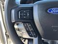 Close-up of the steering wheel controls of a 2017 Ford F-550 with buttons for navigation and settings
