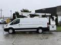 A white 2019 Ford Transit van with an elevated work platform attached to the roof