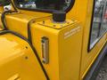A yellow Bombardier SW48 with a label indicating hydraulic oil and a gauge for monitoring fluid levels