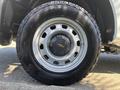 Close-up of a silver wheel on a 2011 Chevrolet Colorado featuring a black tire with tread pattern and the Chevrolet logo in the center of the hubcap