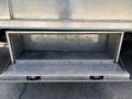 A 2020 Chevrolet Silverado with a metallic storage compartment at the rear that is open and empty