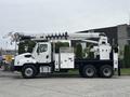 A 2013 Freightliner 114SD bucket truck with a white chassis and a hydraulic lift arm extended for utility work