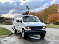A 2007 Ford Econoline van with a roof-mounted equipment rack and orange warning lights on top