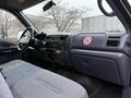 Interior of a 2001 Ford F-350 featuring gray upholstery and a dashboard with controls and a no smoking sign