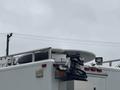 A 2011 Ford F-650 with a large round satellite dish mounted on the roof and various equipment attached to the back