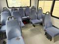Interior of a 2017 Chevrolet Express showing several rows of blue fabric seats designed for passenger transport
