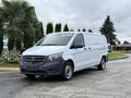 A 2020 Mercedes-Benz Metris van in white with a black front grille and silver wheels is parked on a concrete surface