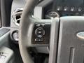 A close-up view of the steering wheel controls in a 2012 Ford F-550 featuring buttons for setup information reset and set