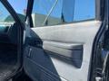 The interior of a 1996 GMC Top Kick showing the driver's side door with a simple handle and an armrest on a textured panel