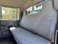 Interior of a 2011 International 4300 showing a gray bench seat with ample space for passengers