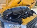 A 2017 Ford Transit-350 with its hood raised revealing the engine compartment and various components including the air intake and battery