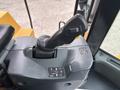 Close-up of the control lever and buttons inside a 2012 Caterpillar 980 heavy machinery operator's cabin
