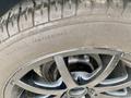 A close-up of a tire and wheel of a 1968 Ford Mustang Two Door Convertible showing a black alloy rim and tread pattern