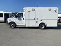 A 2011 Chevrolet Express van with a white exterior and a side door mounted on the passenger side designed for emergency services