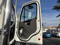 A 2013 Freightliner 114SD truck door is open revealing the interior handle and panel design