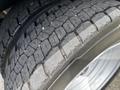 Close-up of a tire from a 2017 Ford F-550 showing deep tread patterns and the rim's metallic finish