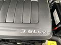 Engine cover of a 2014 RAM Cargo Van displaying the 3.6L VVT emblem