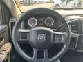 Steering wheel and dashboard of a 2015 RAM 1500 with gauges and controls visible