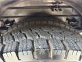 Close-up of a treaded tire on a 1999 Freightliner FL80 showing detailed rubber patterns and grooves