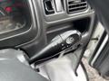 Close-up of the control lever for headlights and turn signals in a 2008 Suzuki Carry