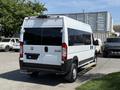 A white 2021 RAM Promaster van with a raised step and a handicap sign on the back door