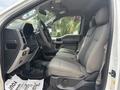 Interior of a 2017 Ford F-150 showing two front seats and steering wheel with controls