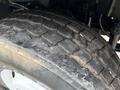 Close-up of a worn tire on a 2012 International 7400 with visible tread patterns and dirt accumulation on the surface