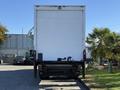 A 2012 Freightliner M2 106 box truck with a white rear door and a hydraulic liftgate positioned facing away from the viewer