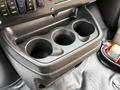 A black cup holder with three compartments in the center console of a 2020 Chevrolet Express