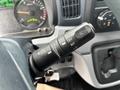 A close-up of the windshield wiper control lever inside a 2015 Mitsubishi Fuso FE160 showing various wiper settings and indicators