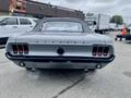 A 1968 Ford Mustang Two Door Convertible with a sleek design visible from the rear featuring classic tail lights and dual exhaust tips