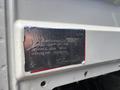 A metal identification plate attached to a 2013 International DuraStar 4300 displaying the vehicle's information and specifications