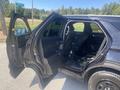 A 2020 Ford Explorer with the front and back doors open showcasing the interior and seating arrangement