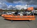 A 2007 Fassmer 20 Foot Fast Rescue Boat in bright orange with a sleek design and roof-mounted equipment, featuring a white and black stripe along the hull