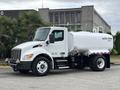 2025 Peterbilt 536 water truck with a white tank and black chassis parked on a concrete surface