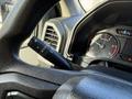 Detail of the steering column in a 2020 Ford F-550 showing the gear shift lever and speedometer gauge