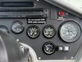 Dashboard of a 2012 Global M4 featuring various gauges for engine RPM fuel and warnings about overspeed and maximum RPM while sweeping