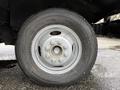 A close-up view of a silver wheel with a five-bolt pattern mounted on a black tire labeled Duravis M108