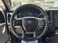 Steering wheel and dashboard of a 2017 Ford F-550 with gauges and controls visible